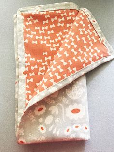 an orange and white cloth folded on top of each other