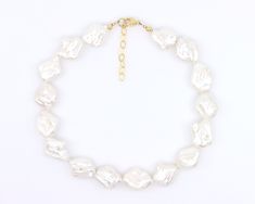 This Large Flat Baroque Pearl Necklace features luxurious, luminescent AAA grade Freshwater pearls with a stunning high luster and iridescent hues of pink, green, and more. Handmade with genuine large 25mm white freshwater pearls, these exquisite gems display a captivating spectrum of colors, including pearly white, purple, pink, blue, and green. The asymmetrical choker design adds a touch of modern elegance to this classic piece, which is finished with gold-filled or sterling silver findings, i White Baroque Pearl Necklace For Party, Choker Design, Choker Designs, Necklace Extender, Baroque Pearl Necklace, White Freshwater Pearl, Beading Wire, Baroque Pearls, Modern Elegance