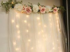 the curtain is decorated with flowers and lights