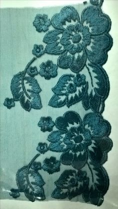 a piece of blue lace with flowers on it