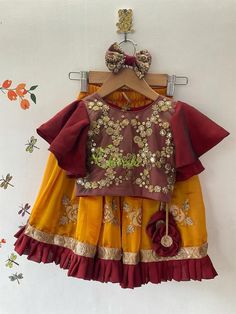 This ethnic lehenga featuring cape sleeve and jerry worked choli and tutu edged skirt accompanied with a sequienced dupatta. Please Visit My Shop For More Unique Collectionhttps://www.etsy.com/shop/ChitralieBUYER'S PLEASE LEAVE YOUR CONTACT NUMBER. It's necessary for shipping.Fabric and WorkCholi: Cape sleeve with jerry and sequence embroidered tulle fabric. The choli is lined in soft cotton fabric and ties at the back. The hanging is made with unique fabric flowers.Skirt: Gathered shimmer georg Maroon Butterfly, Mustard Yellow Lehenga, Ethnic Lehenga, Yellow Lehenga, Butterfly Sleeve, Unique Fabric, Embroidered Tulle, Cape Sleeves, Butterfly Sleeves