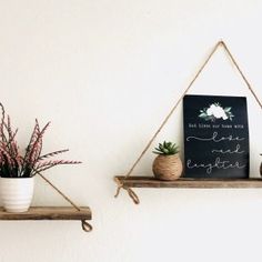 two wooden shelves with plants and signs on them