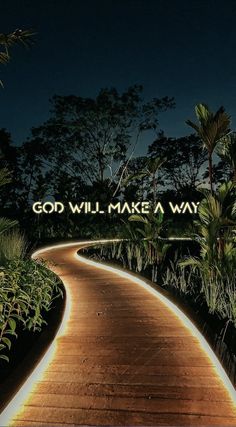 a wooden path with the words god will make a way on it and palm trees in the background