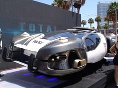 a futuristic car is on display at an auto show