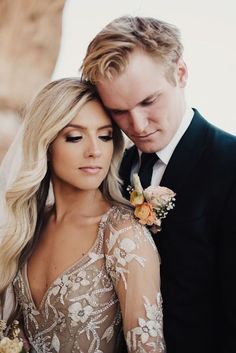 a bride and groom standing next to each other