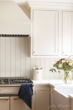 a kitchen with white cabinets and an oven