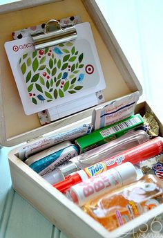 an open wooden box filled with markers and pens