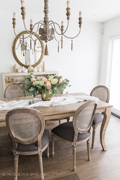 a dining room table with chairs and a chandelier