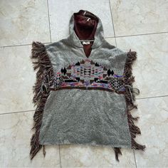 Elan Nwot Fringe Aztec Hoodie Poncho Os Colorful Is Brand New With Tags Removed. Super Comfy And Stretchy. Loose Fitting And Warm! Priced To Sell And Will Ship Out Same Day As Purchased. Open To Offers On All Items. Chm Casual Winter Festival Sweater, One Size Winter Festival Tops, Winter Festival One Size Tops, Hooded Fall Festival Poncho, Casual Hooded Poncho For Festival, Casual Hooded Poncho For Cold Weather, Gray Poncho For Cold Weather In Fall, Casual Gray Long Sleeve Poncho, Aztec Poncho