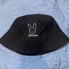 Brand New Never Worn Unisex Badbunny Bucket Hat, Trendy Black Bucket Hat With Short Brim, Trendy Black Cotton Bucket Hat, Trendy Black Bucket Hat For Vacation, Trendy Black Bucket Hat For Spring, Trendy Black Cap-style Bucket Hat, Black Spring Bucket Hat, Black Cotton Bucket Hat For Vacation, Black Cotton Bucket Hat For Summer