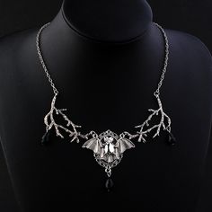 A striking piece of jewelry that embodies the essence of dark magic and Gothic elegance. This intricately designed necklace features a large and detailed bat pendant hanging from a sturdy and stylish chain. The bat pendant is infused with a mysterious energy that radiates from its intricate design, making it a perfect accessory for any wizard or witch seeking to channel their inner power. With its bold and captivating design, this necklace is the perfect statement piece to complete your gothic look. The energy-infused bat pendant adds an air of mystery and intrigue, while the sturdy chain ensures it stays securely around your neck. Whether you're attending a gothic event, seeking to enhance your magical powers, or simply expressing your individuality, the Gothic Mysterious Energy Wizard Ba Gothic Pendant Necklace For Halloween, Halloween Gothic Pendant Necklace, Gothic Halloween Chain Necklace, Black Fantasy Pendant Necklace, Fantasy Black Pendant Necklace, Black Metal Fantasy Necklace, Pagan Magic, Bat Pendant, Bat Necklace