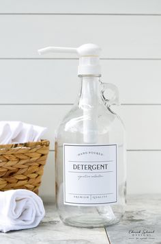 a bottle of deterant sitting next to a basket and towel on a counter top