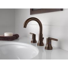 a bathroom sink with two faucets and soap dispenser