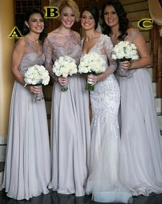 the bridesmaids are all dressed in gray dresses and holding bouquets, posing for a photo