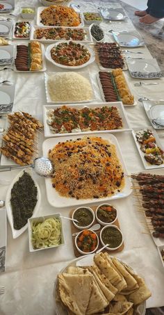 a table filled with lots of food on top of plates and bowls next to each other