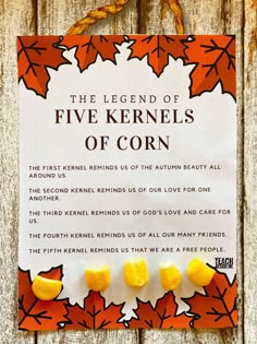 the legend of five kernels of corn is displayed on a wooden fence with autumn leaves