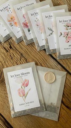 five packets of let love bloom tea on a wooden table next to a wax seal