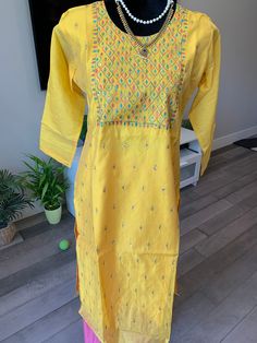 Beautiful, Chanderi silk kurti that can be worn casually on jeans or leggings for a small party. The kurti comes with elegant sequin work on the neck yoke and body, that glitters elegantly from the intricate embroidery work. Size of kurti: L (40 inches bust) Size L: Chanderi Silk Kurti with Sequin and Embroidery Work | Indian Kurtis online shopping usa | silk kurtis online Yellow Slub Silk Salwar Kameez With Dori Work, Yellow Slub Silk Churidar For Festivals, Navratri Tussar Silk Kurta With Dori Work, Navratri Cotton Silk Traditional Wear With Dori Work, Yellow Slub Silk Kurta With Pallu Detail, Yellow Slub Silk Kurta With Pallu, Festival Tussar Silk Kurta With Dori Work, Traditional Yellow Slub Silk Set, Bollywood Style Multicolor Slub Silk Kurta