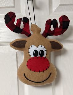 a stuffed reindeer head hanging on the front door