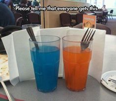 two glasses filled with liquid sitting on top of a table