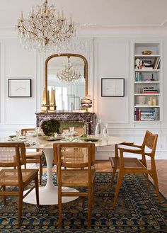 a dining room table with chairs and a chandelier