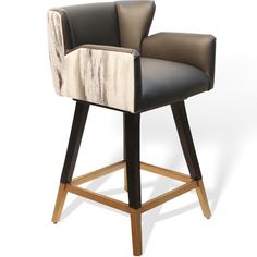 an upholstered bar stool with black leather and white fabric on the armrests