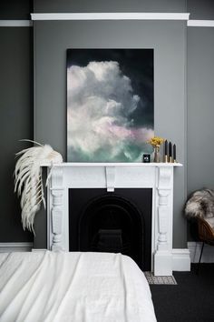 the instagram page shows an image of a bedroom with grey walls and white fireplace