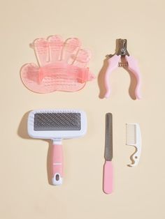 a pink hairbrush, comb and other items on a table