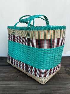 a woven basket sitting on top of a wooden floor