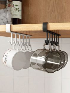 pots and pans are hanging from the kitchen shelf