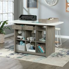 a desk with drawers and a clock on the wall above it in a living room