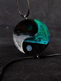 Yin yang couple necklaces, aurora northern lights, Matching necklaces Birthday gift Wood resin couple pendants, perfect gift for her Our handmade resin necklaces are individually crafted using high-quality black hornbeam wood impregnated with eco-friendly protective oils and finished with polished resin for a stunning mirror-like shine. Each piece is truly unique and made to order, ensuring a luxurious, smooth finish. The necklace features a black waxed cotton cord with stainless steel fittings and lobster clasp that can be customized to your preferred length. Your necklace will arrive packaged in a box, making it a perfect gift for any occasion. Please note that as each necklace is custom-made, it may take up to 2 weeks for us to complete your order.Wood resin yin Yang aurora couple neckl Resin Moon Couple Necklace, Couple Crystal Necklace, Matching Necklaces For Couples Pendants, Mystical Black Necklace For Gift, Mystical Black Jewelry Gift, Mystical Black Jewelry For Gifts, Mystical Resin Necklaces For Gifts, Mystical Green Jewelry For Gift, Mystical Green Jewelry As Gift