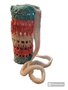 a crocheted bag with a handle is shown on a white background and has a loop in the shape of a house