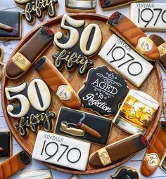 decorated cookies are arranged in the shape of 50th birthday signs and numbers on a platter