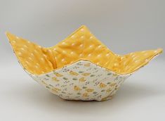 a yellow and white bowl sitting on top of a table