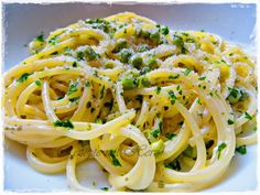 pasta with broccoli and parmesan cheese on a white plate