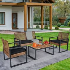 the patio furniture is set up outside on the grass