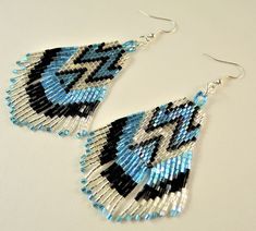 Welcome to Kartika Earrings Australia. You are buying, 1 Pair of Miyuki Handmade Beaded Dangle Fashion Statement Earrings. BEADED PATTERN SIZE - 65mm Long X 35mm Wide OVERALL EARRING LENGTH - 80mm Long COLOURS - Blue Black and Silver SILVER HOOKS - LEAD FREE, NICKEL FREE, CADMIUM FREE ALL OUR EARRINGS ARE HANDMADE IN AUSTRALIA We post every morning and afternoon. Please allow 3 - 10 days postage time within Australia. Please allow 10 - 28 days postage Worldwide. Thank you Regards Kartika Earring Blue Dangle Earrings With Black Beads, Adjustable Blue Earrings With Black Beads, Blue Dangle Jewelry With Black Beads, Statement Earrings Silver, Native Earrings, Earrings Patterns, Earrings Beaded, 28 Days, Earrings Silver