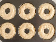 six donuts in a muffin tin ready to be baked