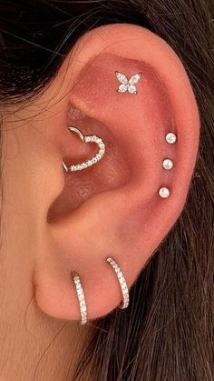 a woman with three different piercings on her ear