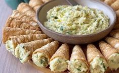 a platter filled with croissants and dip