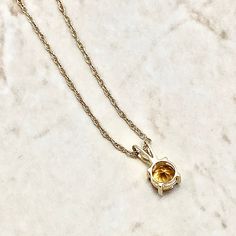 Beautiful pendant necklace crafted in 14 karat yellow gold. It features a natural 5 mm round citrine, the birthstone for November! The gemstone weighs approximately 0.45 carat. It comes with an 18-inch 14 karat yellow gold chain. Birthstone: November. Condition: Brand New. - 14 day return policy, no questions asked. - Free insured shipping in the US. - International shipping available. Note: All items have been appraised and inspected by a jewelry specialist and certified gemologist (GIA GG). All diamond and gemstone gradings are done under GIA standards as the mounting and setting permit. All gemstone weights and item measurements are approximate. All diamond colors and clarities are based on the opinion of our experienced gemologist. Feel free to call or message us if you have any questi Yellow Gold Birthstone Necklace With Round Stone, Yellow Gold Citrine Round Pendant Necklace, Yellow Gold Solitaire Pendant Necklace With Birthstone, Yellow Gold Citrine Birthstone Necklace, Yellow Gold Round Birthstone Solitaire Necklace, Yellow Gold Solitaire Necklace With Birthstone, Yellow Gold Birthstone Necklace With Prong Setting, Yellow Gold Solitaire Necklace With Gemstone Pendant, Yellow Gold Solitaire Gemstone Necklace