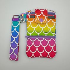 Cute Rainbow Wristlet Phone Wallet - Fabric Credit Card Wallet - Gift for Rainbow Lover This adorable rainbow wristlet phone wallet is perfect for running errands in style! Features three card slots, a slip pocket for your phone and a zipper pocket. Perfect for rainbow lovers, or as a gift for one! Details: -Material: Cotton -Dimensions: 4.25" wide and 6.5" tall (best suited for smaller phones, my iPhone 14 Pro Max does fit but it is a bit tight) -Snap Closure: Plastic -Zipper: Nylon -Item is ready to ship :) Shipping: -Once your order is shipped, I'm no longer responsible for the package. It's the United States Postal Service (USPS) who takes over the responsibility of delivering it to you. If there are any issues with the delivery or a missing package, please send me a message, and I wil Adjustable Rectangular Wristlet Mobile Phone Bag, Adjustable Rectangular Wristlet For Mobile Phone, Multicolor Phone Bag With Cell Phone Pocket As Gift, Multicolor Everyday Wallet With Mobile Phone Bag, Multicolor Wristlet With Card Slots For Daily Use, Everyday Multicolor Wristlet With Card Slots, Multicolor Wristlet With Cell Phone Pocket As Gift, Multicolor Rectangular Wristlet With Mobile Phone Bag, Multicolor Rectangular Wristlet For Mobile Phone