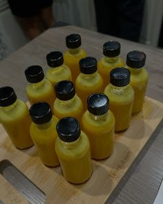 there are many yellow bottles on the cutting board