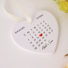 a white heart shaped ornament with a red heart on it