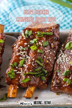 slow cooker chinese spare ribs on a plate with sesame seeds and green onions in the background