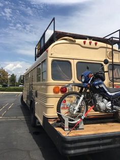 a motorcycle is parked on the back of a bus