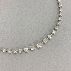 A classic and elegant everyday or occasional wear with graduating diamond sizes, this Space Necklace is a fresh take on a versatile piece of jewelry. All our necklaces have two locks for added security. Center Diamond Weight: 1.00 ct Center Diamond Color: I Center Diamond Clarity: SI (Slightly Included) Total Diamond Weight: 11.53 ct No. of Diamonds: 77 Diamond Color: H - J Diamond Clarity: SI - I (Slightly Included - Included) Metal: Platinum Metal Wt: 32.15 gms Setting: Prong Set Length: 15.75 Classic Crystal Diamond Necklace With Brilliant Cut, Classic Crystal Tennis Necklace With Brilliant Cut, Classic Brilliant Cut Crystal Diamond Necklace, Classic Crystal Diamond Necklace With Accents, Classic Round Cut Crystal Diamond Necklace, Formal Crystal Necklace With Brilliant Cut, Classic Bridal Necklace With Brilliant Cut Crystal, Classic Round Cut Crystal Necklace, Classic Diamond Cut Crystal Tennis Necklace