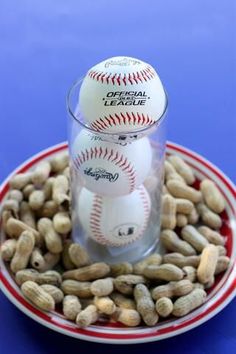 baseballs and peanuts in a glass on a plate