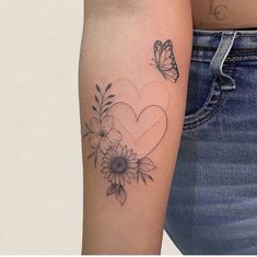 a woman's arm with a butterfly and flower tattoo on the left side of her arm